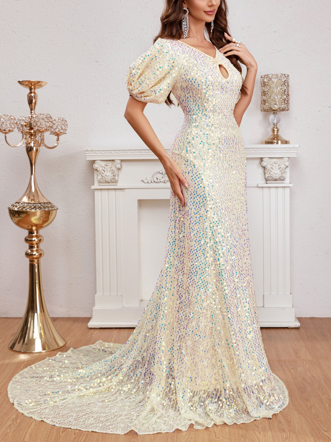 Side view of an apricot puff sleeve multicolor sequined evening dress showcasing the elegant silhouette and floor-length trailing hemline.