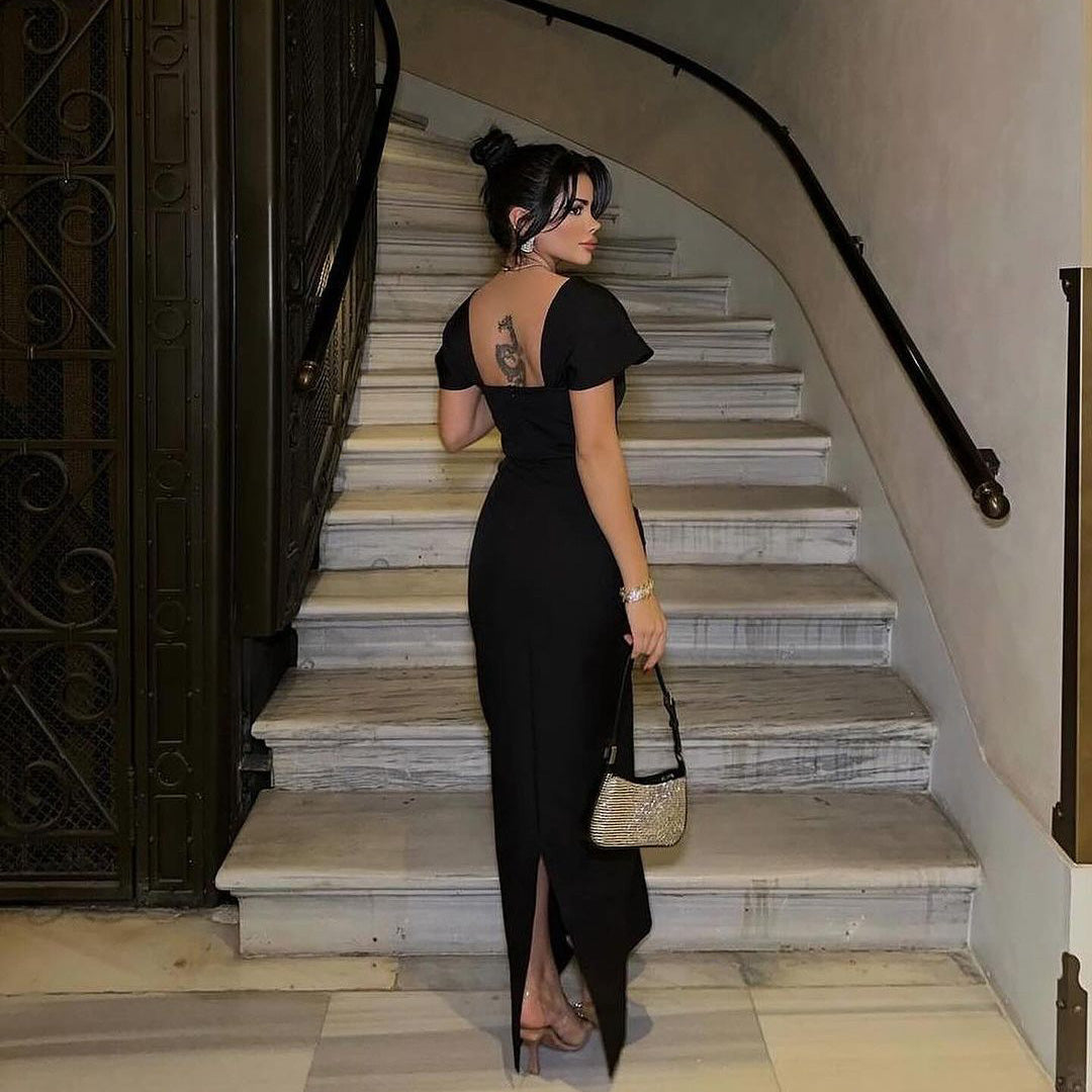 Back view of the Black Neck Rhinestone Low Slit Maxi Dress featuring a stunning backless design and figure-hugging fit.