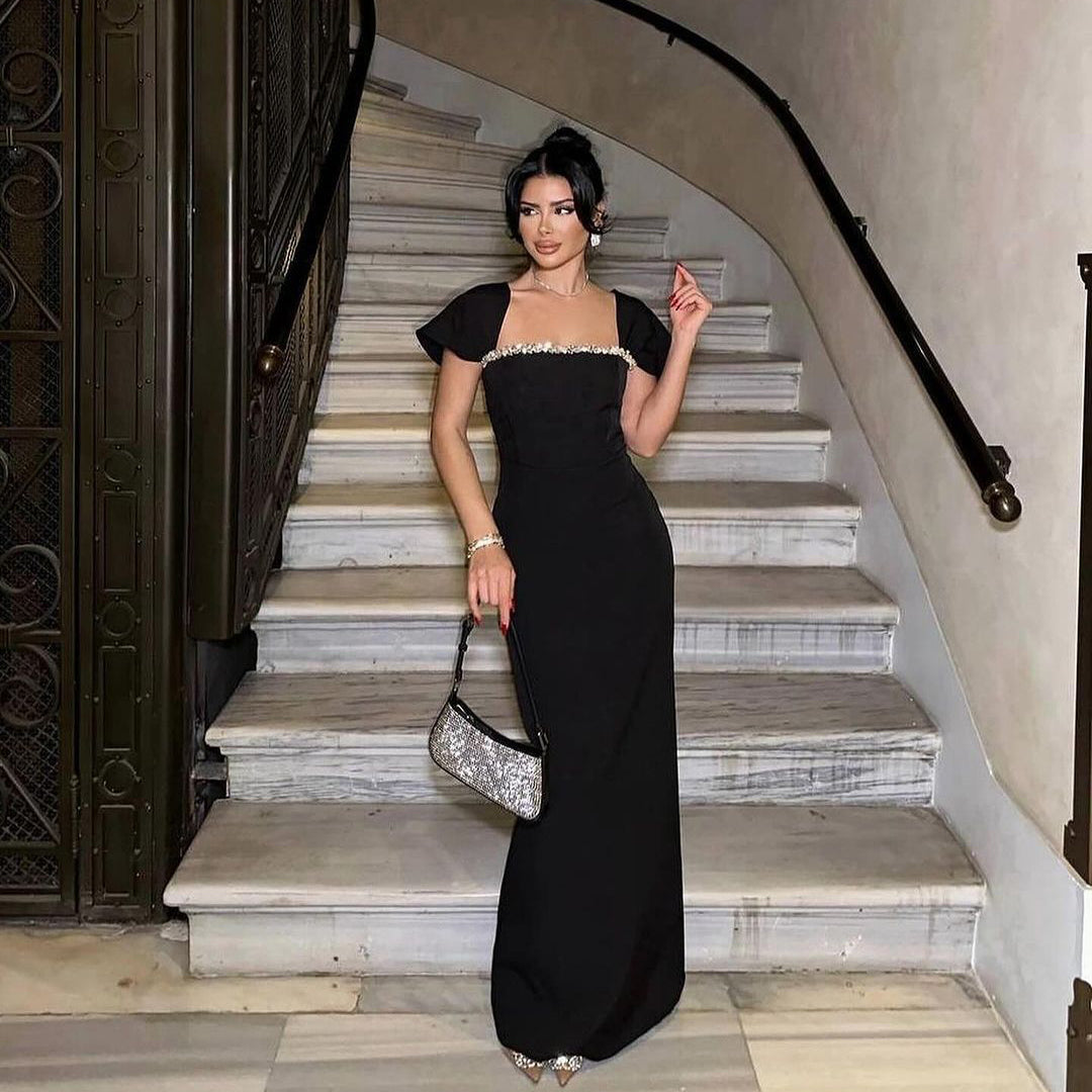 Front view of the Black Neck Rhinestone Low Slit Maxi Dress showcasing the elegant rhinestone neckline, sleeveless design, and floor-length silhouette.