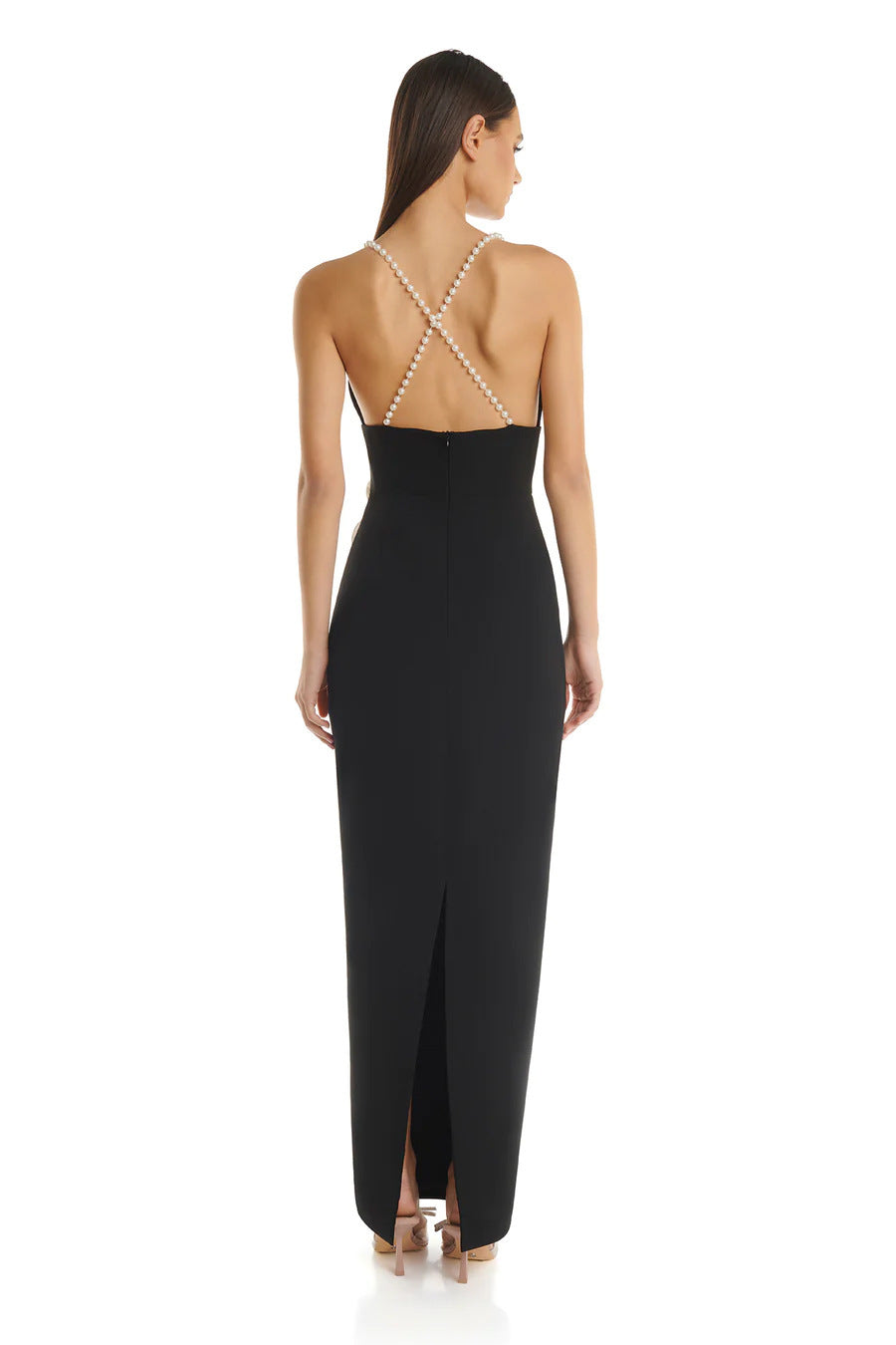 Back view of a black evening dress showcasing pearl cross-back suspenders and a low slit for an elegant finish.