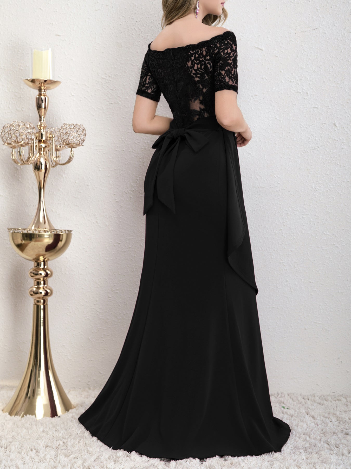 Back view of the Yedda black short sleeve embroidered lace spliced A-line dress, featuring the lace splicing and bow detail.
