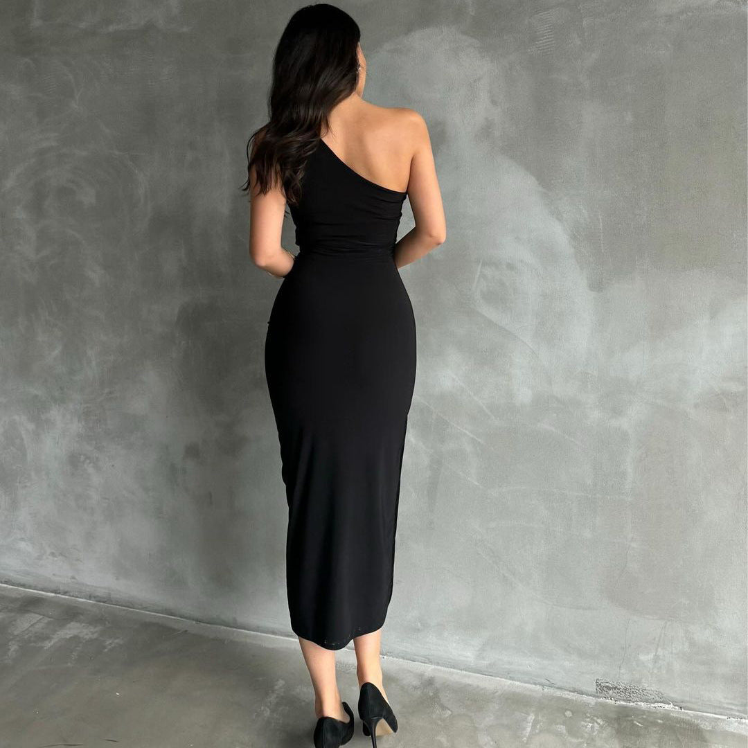 Back view of the Black Sleeveless One Shoulder Slit Stretch Midi Dress, showing off the backless design and smooth, sleek lines.