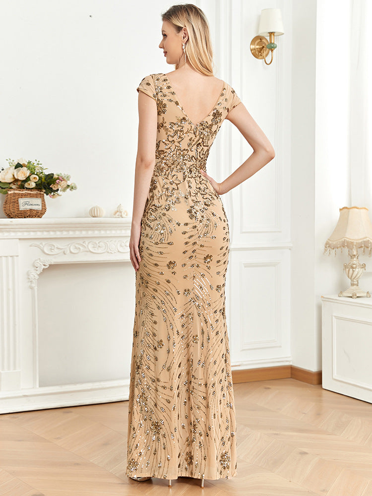 Back view of a champagne mermaid dress with a sophisticated backless design and flowing mermaid skirt for a timeless formal look.