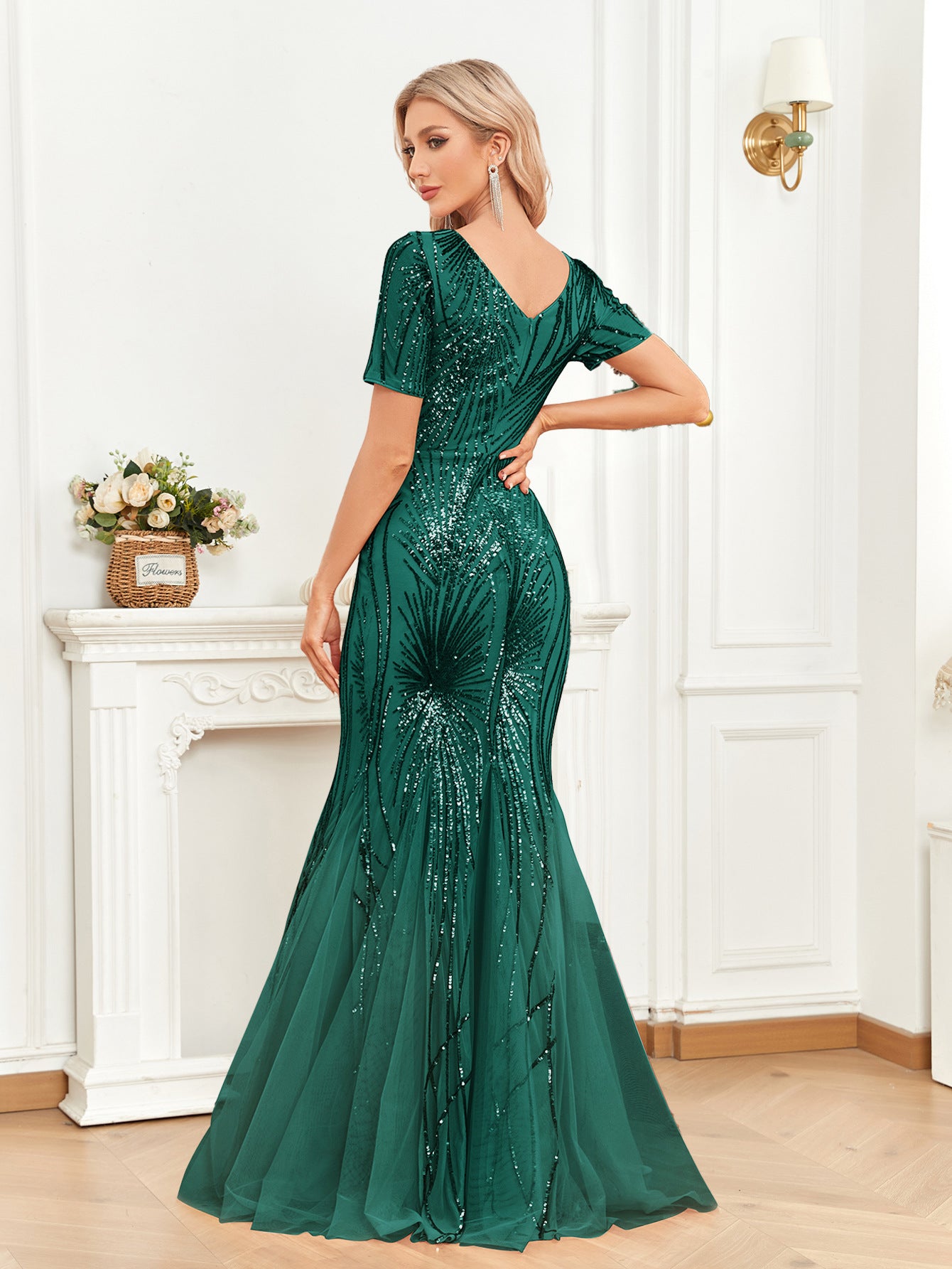 Back view of the Rae Green Mermaid Dress with a dramatic fishtail hem, delicate sequin patterns, and a graceful low-back design ideal for formal occasions.