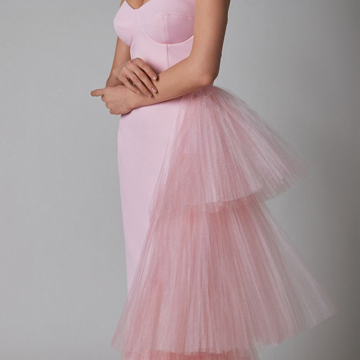 Close-up detail view of the pleated mesh splicing and stretch fabric of the pink sleeveless maxi dress, emphasizing the texture and quality.