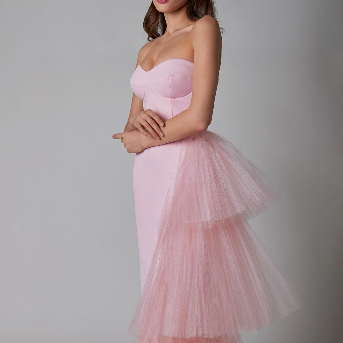 Side view of the pink sleeveless pleated mesh splicing stretch maxi dress, highlighting the smooth silhouette and pleated mesh detail.