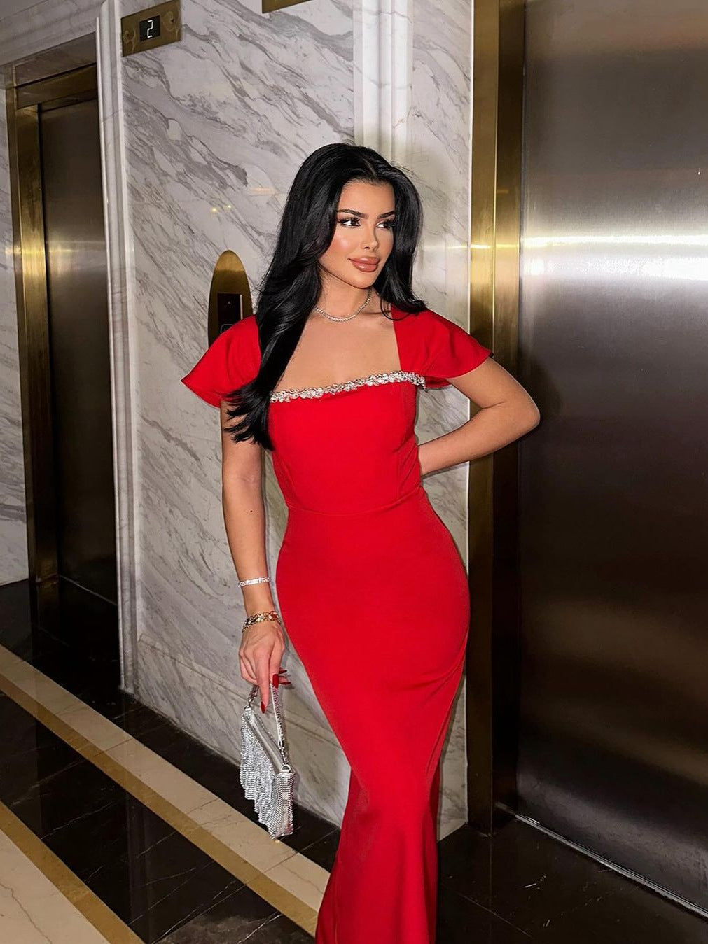 Side view of the Red Neck Rhinestone Low Slit Maxi Dress highlighting the flattering high slit and graceful side silhouette.
