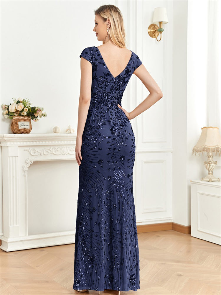 Back view of a royal blue mermaid dress with a sophisticated backless design and flowing mermaid skirt for a timeless formal look.