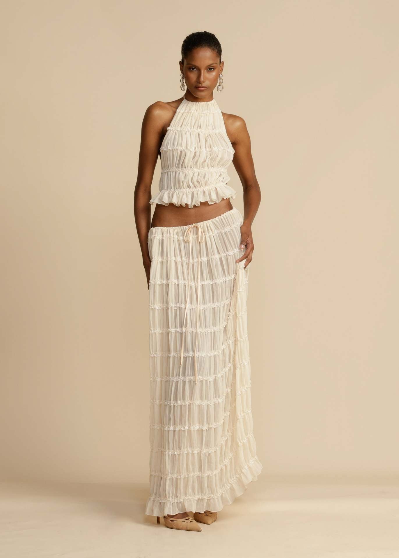 Front view of the White Chiffon Backless Lace-up Pleated Maxi Dress, showcasing the elegant pleated design and hanging neck style.
