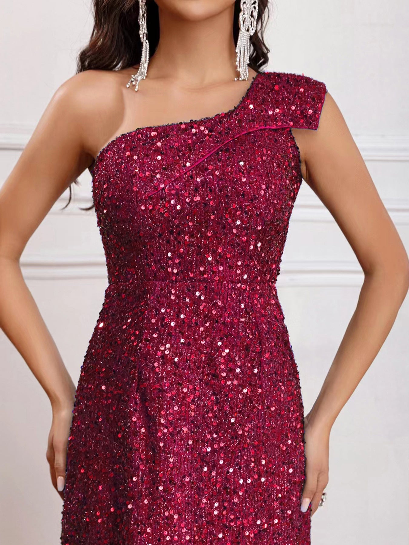 Close-up detail view of the Wine Red Sleeveless One-Shoulder High Slit Sequins Maxi Dress, showcasing its shimmering sequins and high-quality craftsmanship.