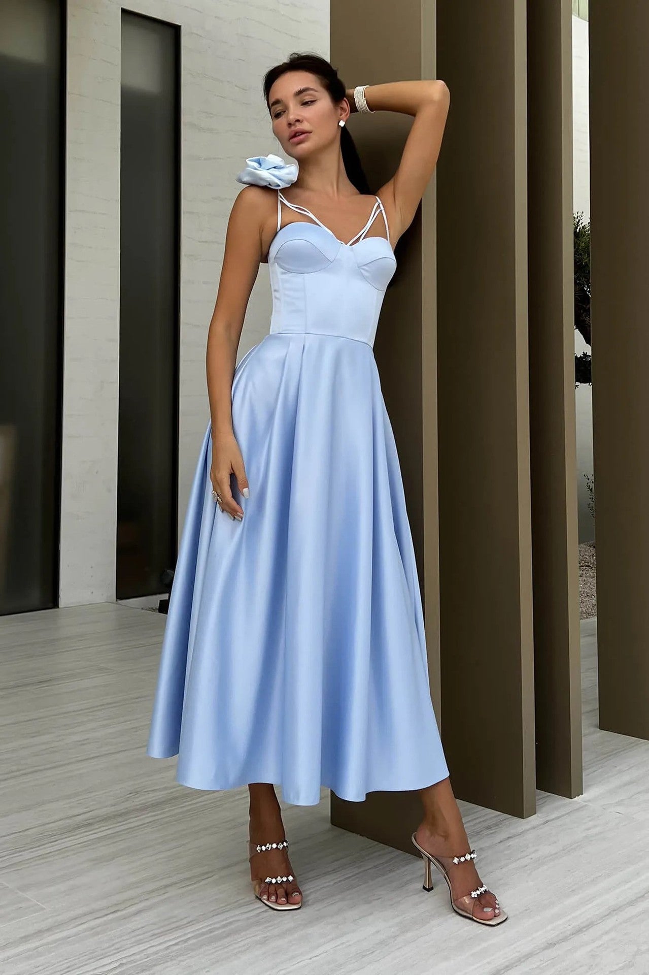 Side view of the Blue Hollow & Flower Decoration Suspender Midi Dress showcasing the flowy A-line skirt and hollow suspender strap details.