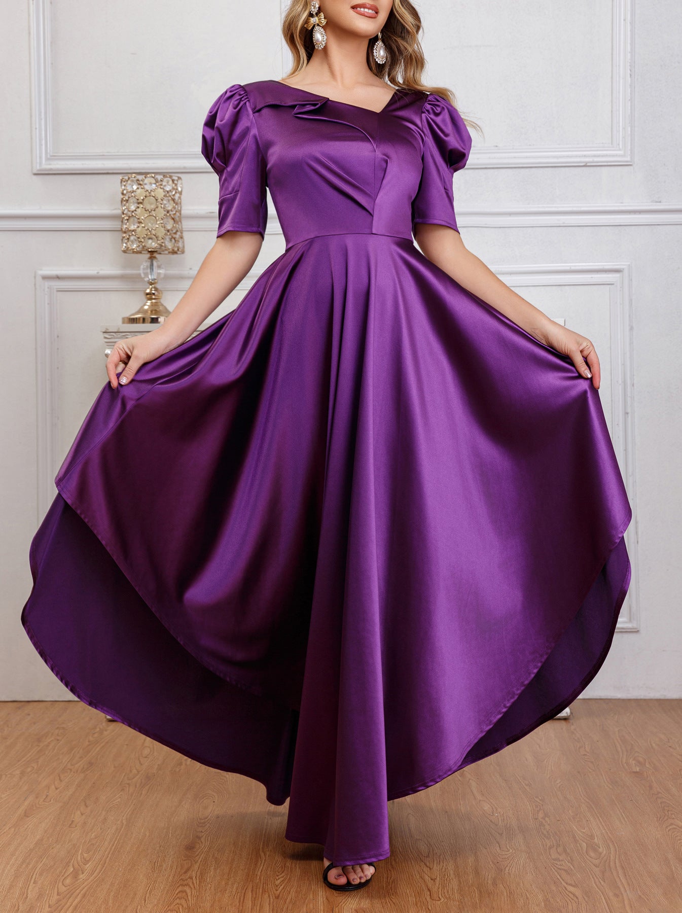 Close-up view of the puff sleeves and pleated details of the purple satin dress, highlighting its luxurious texture.