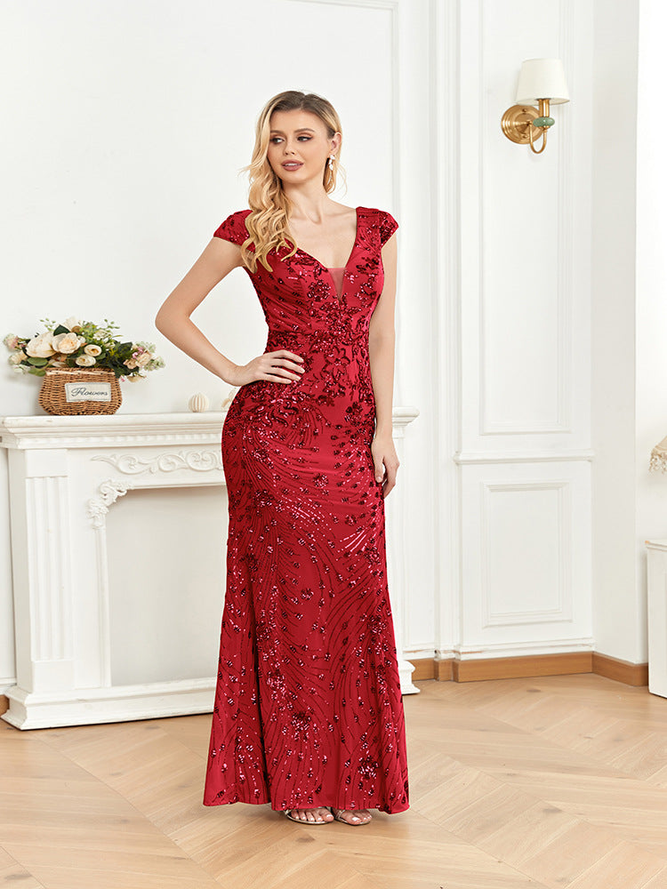 Close-up of the intricate sequin embellishments and floral patterns on the red mermaid dress, highlighting its luxurious craftsmanship.